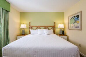 Unwind in the cozy master bedroom featuring a queen bed, perfect for a peaceful night's sleep after a day at the beach.