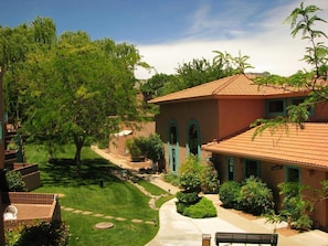 Enjoy serene red rock views and lush greenery from your balcony at this beautifully landscaped property with direct access to hiking trails.