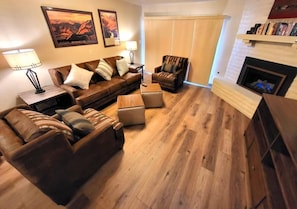 Cozy up by the fireplace in the spacious living area, designed for comfort and relaxation after a day of hiking the nearby trails.