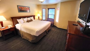 The cozy bedroom invites you to unwind, offering ample natural light and comfortable furnishings for a peaceful retreat.