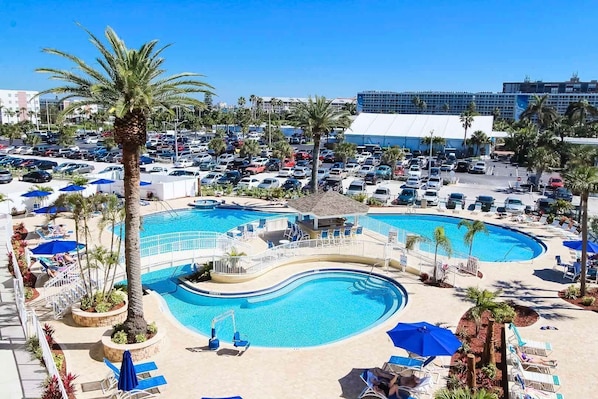 Embrace the lush palm surroundings of the shared pool facilities, offering a refreshing retreat with beach access.