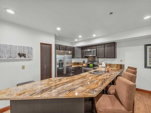 Kitchen: Main floor, drip coffee maker, Keurig, toaster, cooking utensils, tableware

