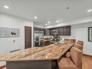 Kitchen: Main floor, drip coffee maker, Keurig, toaster, cooking utensils, tableware