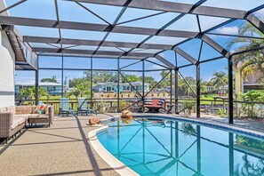 Screened, heated pool with waterfront views.