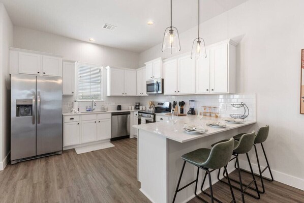 Share a meal, pour a drink, and enjoy good company around this inviting kitchen island.