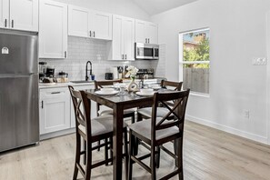 Charming dining table that sits 4 with full tableware and silverware included.