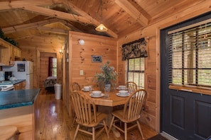 Dining table with seating for four at Boogie Bear, a 1-bedroom cabin rental located in Gatlinburg