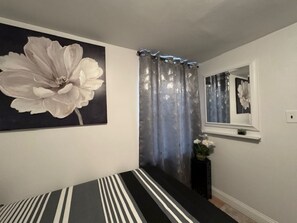 Bedroom 1 has one full-size bed (sleeps 2) and a twin bed (sleeps 1)