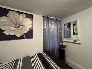 Bedroom 1 has one full-size bed (sleeps 2) and a twin bed (sleeps 1)