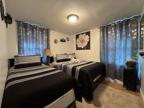 Bedroom 1 has one full-size bed (sleeps 2) and a twin bed (sleeps 1)