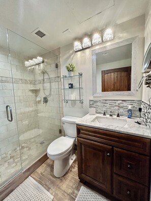Master Bath has a roomy all glass walk in shower.