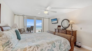 Wake up to breathtaking ocean views in this elegant Gulf-front master bedroom. Featuring a plush king-sized bed with a tropical quilt, rich wooden furnishings, and direct access to the balcony, this space is designed for serenity. Unwind with the sea bree