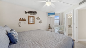 This charming second bedroom features a cozy king-sized bed with a coastal-inspired quilt and playful beach décor. Enjoy a peaceful night’s sleep while taking in natural light from the large window or unwind with your favorite show on the mounted flat-scr