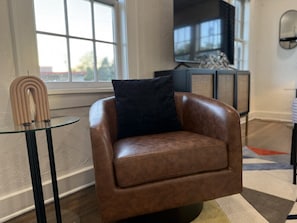 Leather accent chairs create seating areas for reading or relaxing.