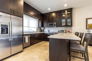 Modern kitchen with bar seating — perfect for casual meals or chatting while you cook