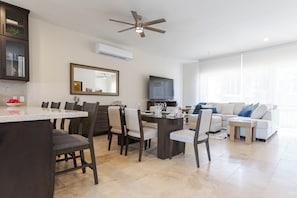 Open-concept living and dining area with plenty of natural light — perfect for relaxing or entertaining, all visible from the kitchen