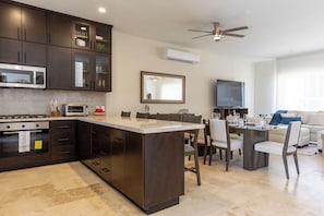Open-concept living space combining kitchen, dining, and living areas for a spacious, airy feel.