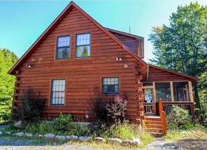 Log cabin with privacy and plenty of outdoor seating areas.