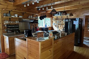 Kitchen with drip coffee maker, blender, fridge, toaster oven, dishwasher.