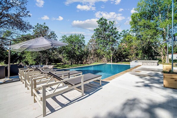 The sparkling pool features a built-in hot tub, offering the perfect combination of refreshing swims and relaxing soaks.