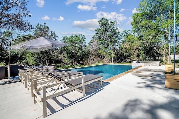 The sparkling pool features a built-in hot tub, offering the perfect combination of refreshing swims and relaxing soaks.