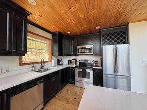 Modern kitchen with stainless steel appliances, double sink and dishwasher