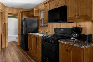 Full kitchen with fridge, stove, oven, microwave, toaster & drip coffeemaker
