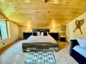 King bed with picture window to take in the view of nature and Lake Superior