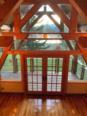 Dining room doors lead to wrap around deck