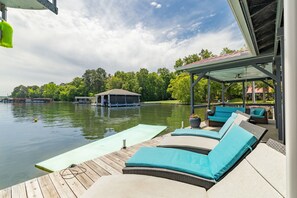 Private dock with seating, fridge, Smart TV, and upper deck.