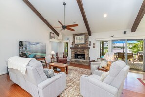 85" Smart TV, fireplace, and comfy seating.