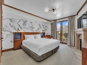 Bedroom 1: King bed, main floor, en-suite bathroom with standalone tub and shower, Smart TV, fireplace, private patio