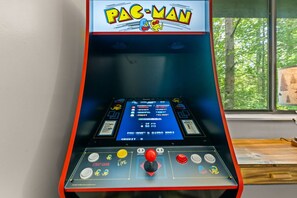 Tucked beside the windows, this classic Pac-Man arcade adds a splash of nostalgic fun to your mountain retreat.