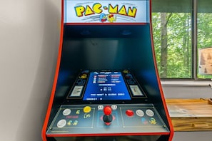 Tucked beside the windows, this classic Pac-Man arcade adds a splash of nostalgic fun to your mountain retreat.