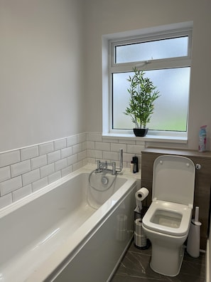 Bathroom with toilet, sink, bath & shower cubicle.