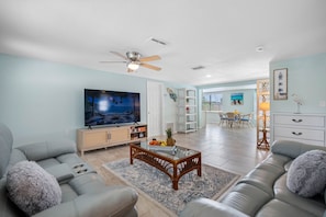 Unwind in the spacious living room, featuring a large, plush sectional sofa perfect for movie nights, mid-day naps, or cozy conversations.