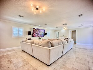 At the center of the room is a large smart TV, equipped with access to popular streaming platforms.