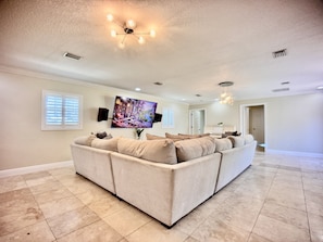 At the center of the room is a large smart TV, equipped with access to popular streaming platforms.