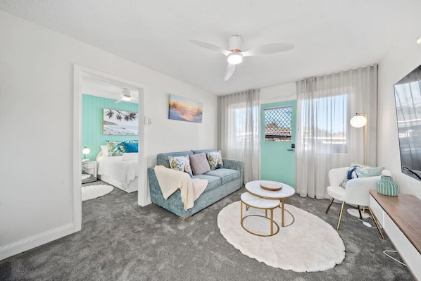 Cosy, sunlit living space with comfy seating—ideal for relaxing