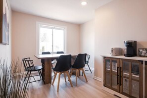 Elegant dining area with a large table and comfortable seating, perfect for gathering with family and friends for a meal.