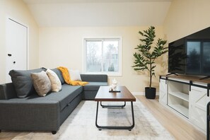 Spacious living room with stylish decor, perfect for unwinding after a day of exploring the local area.