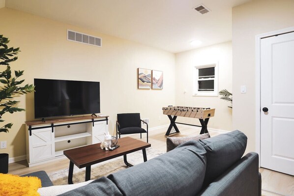 Spacious living room with stylish decor, perfect for unwinding after a day of exploring the local area.