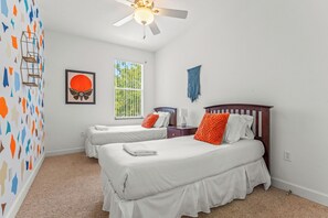 Cheerful double twin bedroom with vibrant, colorful walls