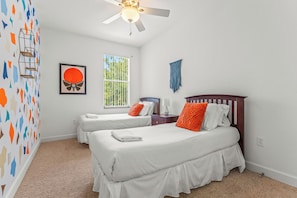 Cheerful double twin bedroom with vibrant, colorful walls