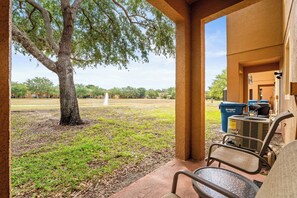 Cozy patio with seating for two and a relaxing garden view