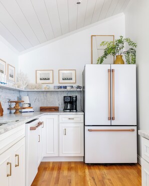 Large kitchen w/marble counters, backsplash and shelf. High-end Cafe appliances.