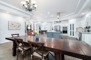 Elegant dining room with large wooden table, perfect for family gatherings.