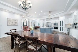 Elegant dining room with large wooden table, perfect for family gatherings.