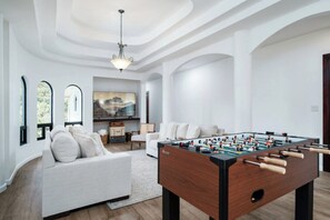 Unwind on plush couches while enjoying the 75" smart TV and foosball table.