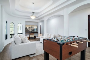 Unwind on plush couches while enjoying the 75" smart TV and foosball table.
